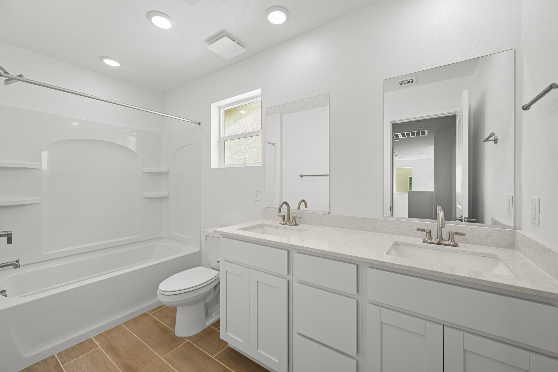 A bathroom with a tub sink and toilet.