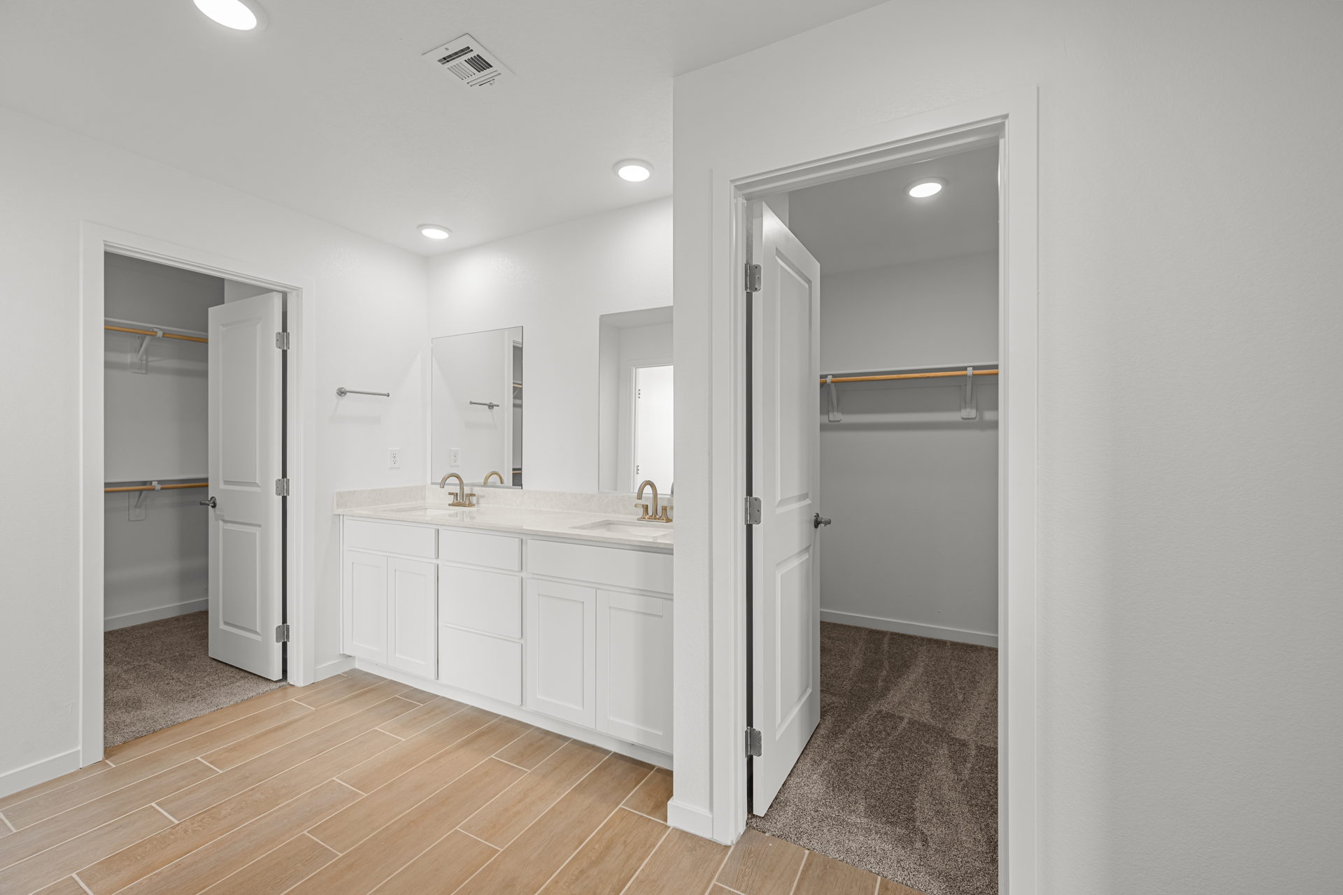 A bathroom with white cabinets.