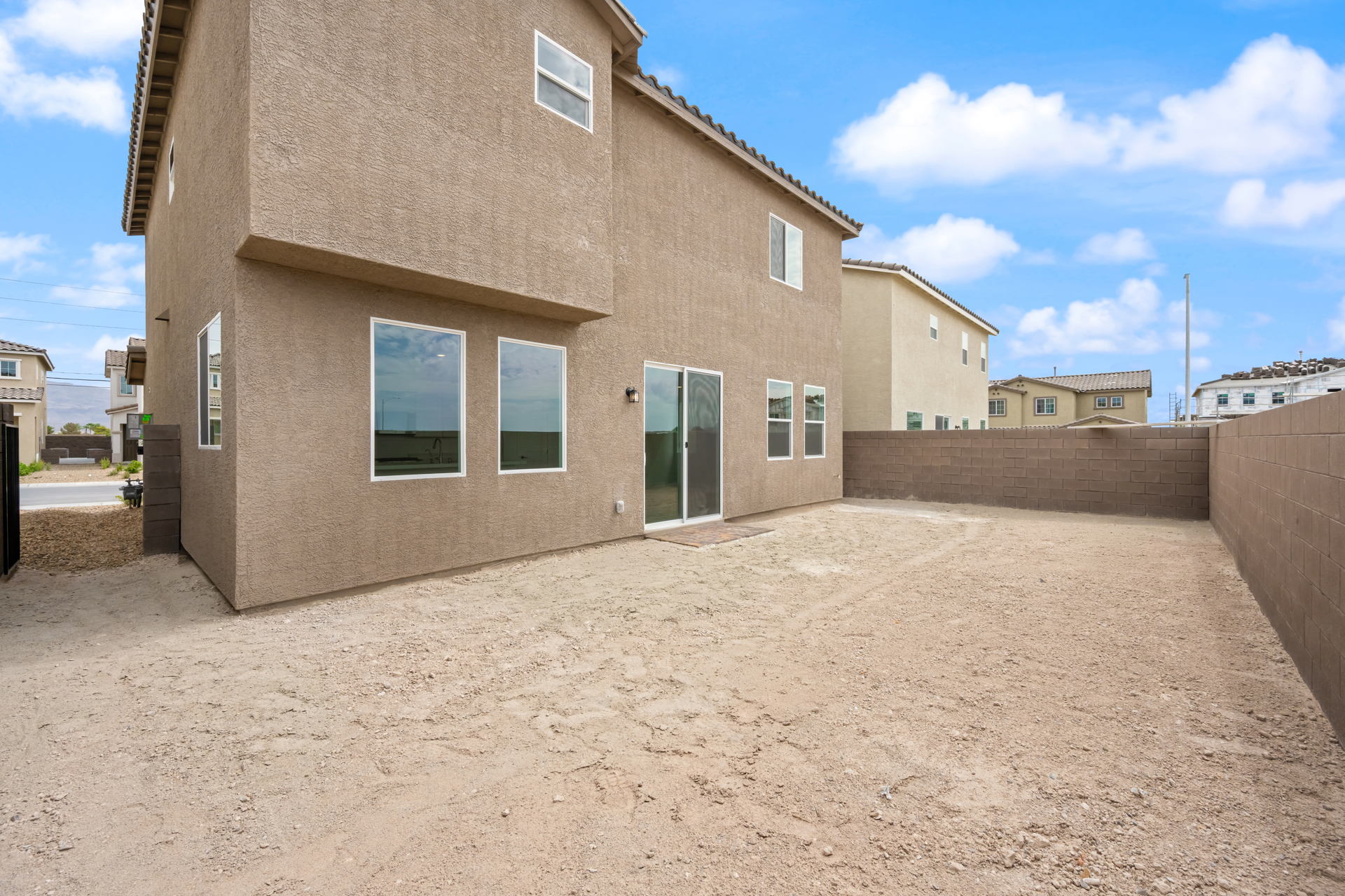 A building with a dirt lot.