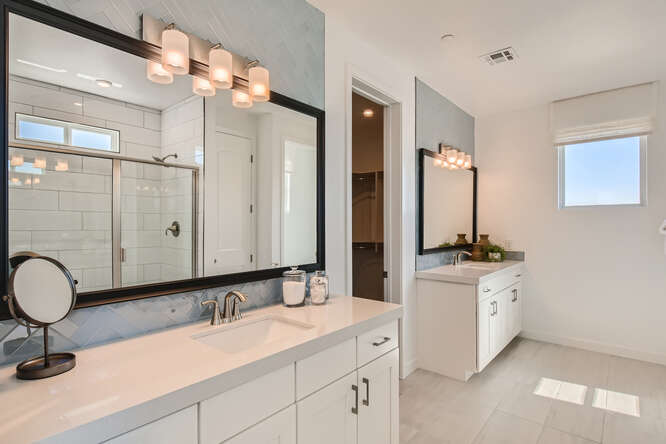 A bathroom with a large mirror.
