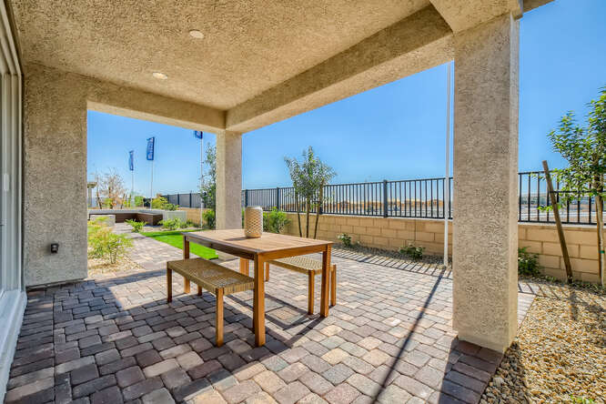 A patio with a table and chairs.