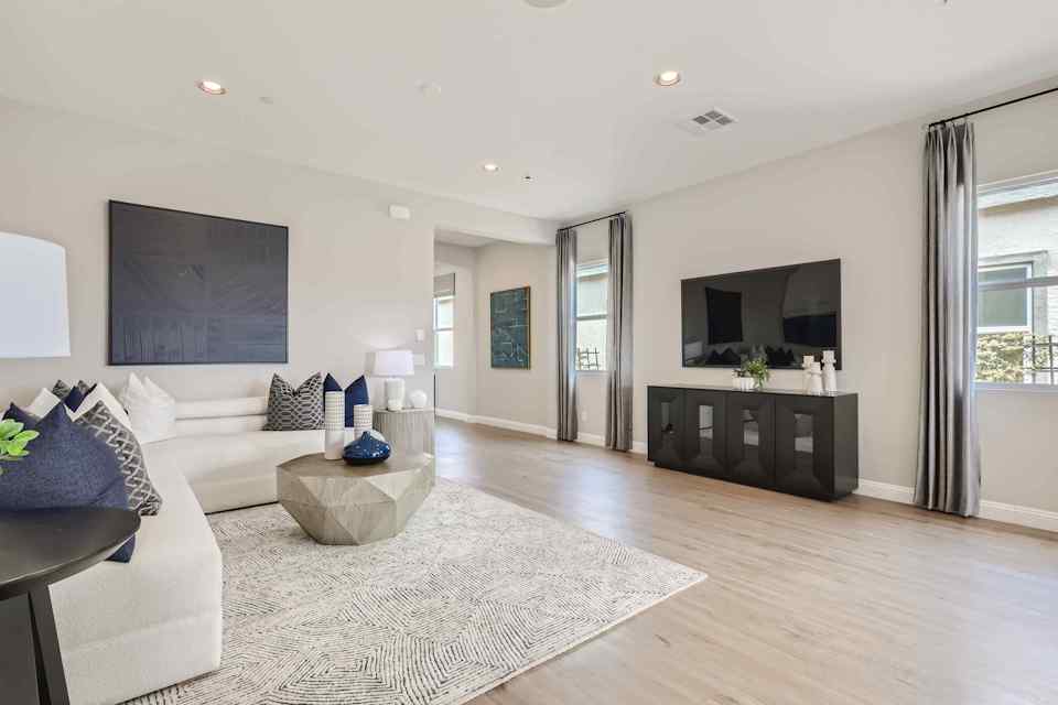 A living room with a large television.