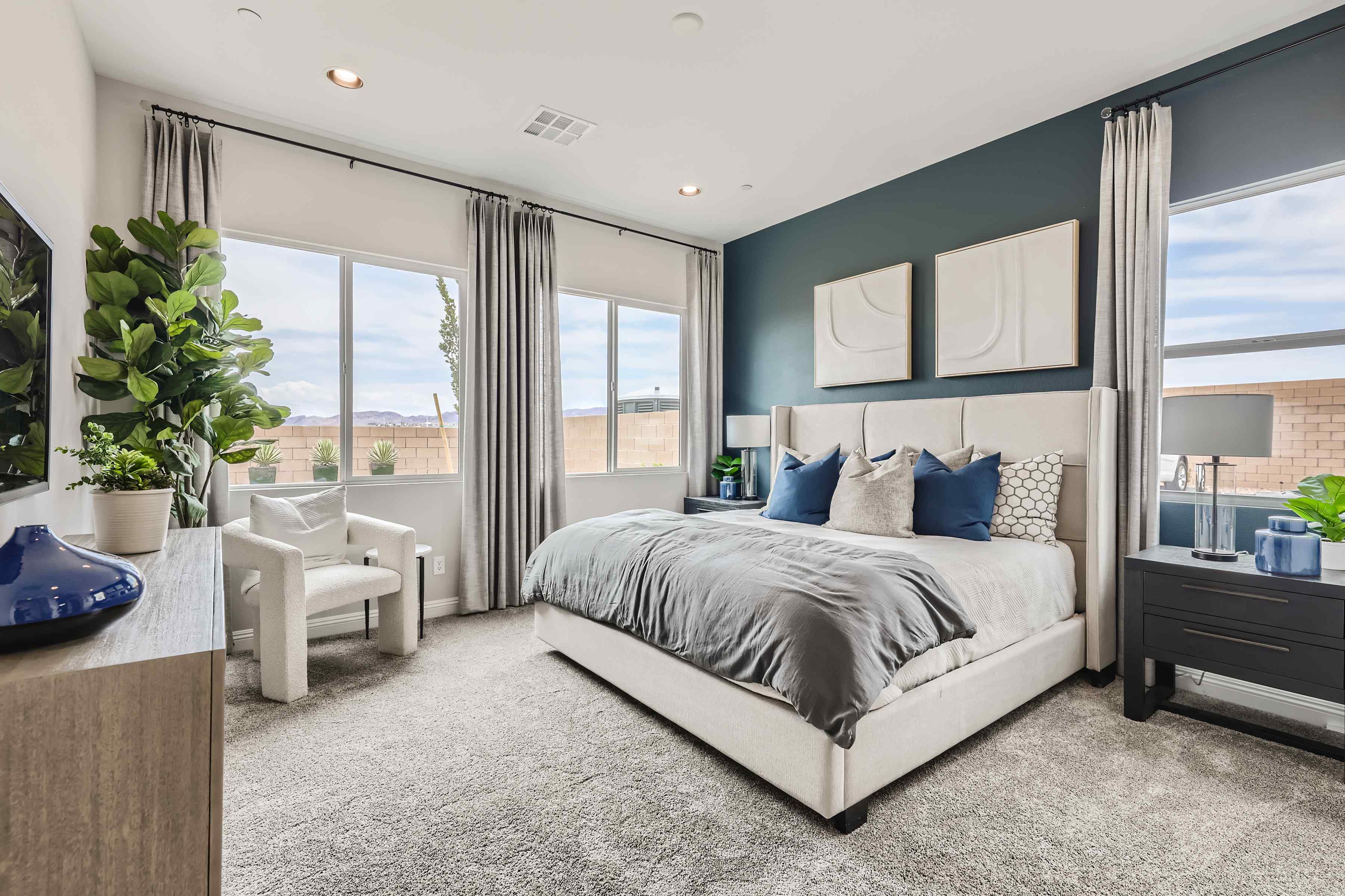 A bedroom with a large window.