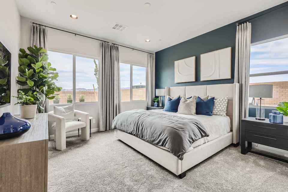 A bedroom with a large window.