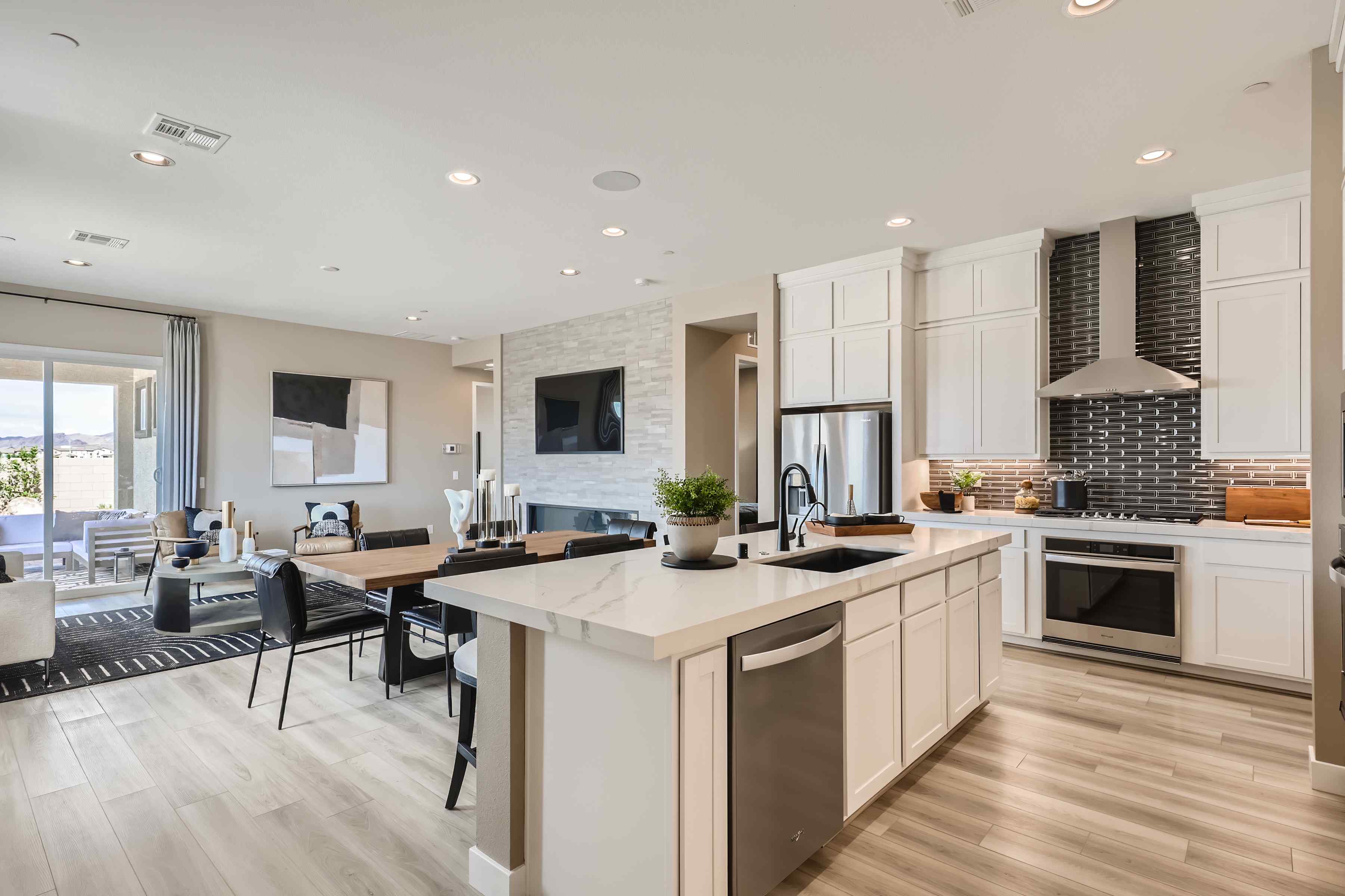 A kitchen with a bar and chairs.