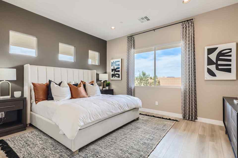 A bedroom with a large window.