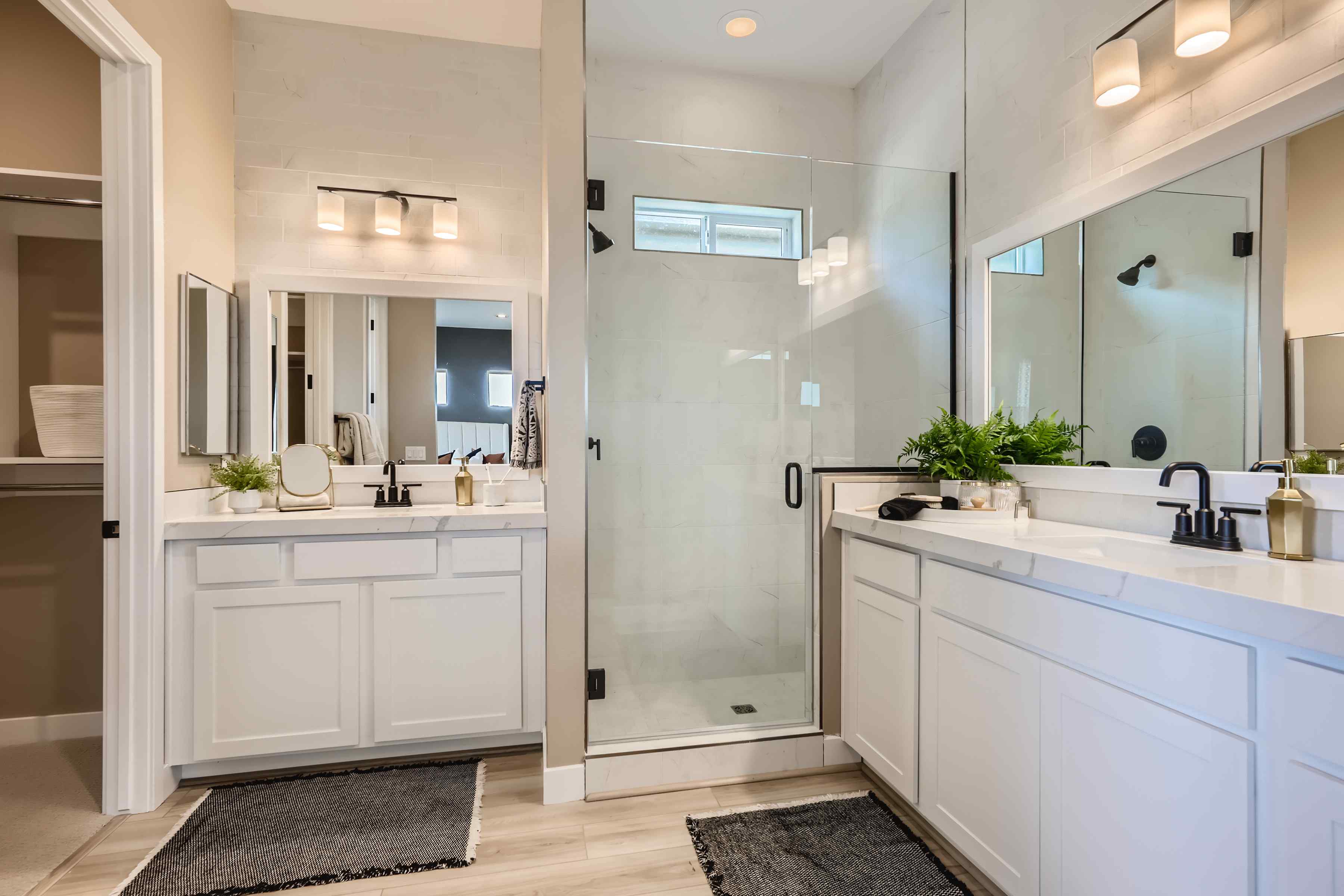 A bathroom with white cabinets.