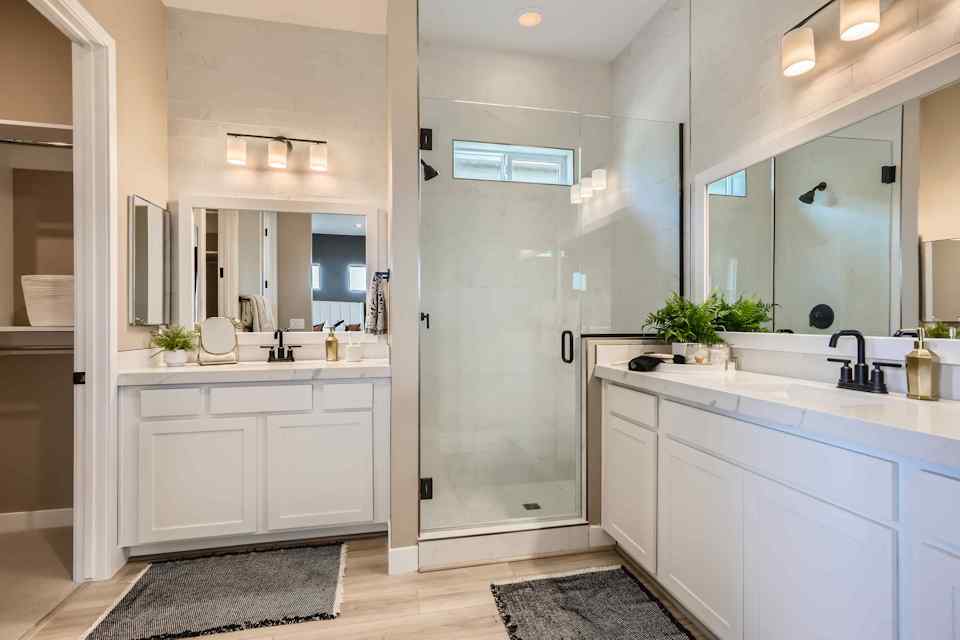 A bathroom with white cabinets.