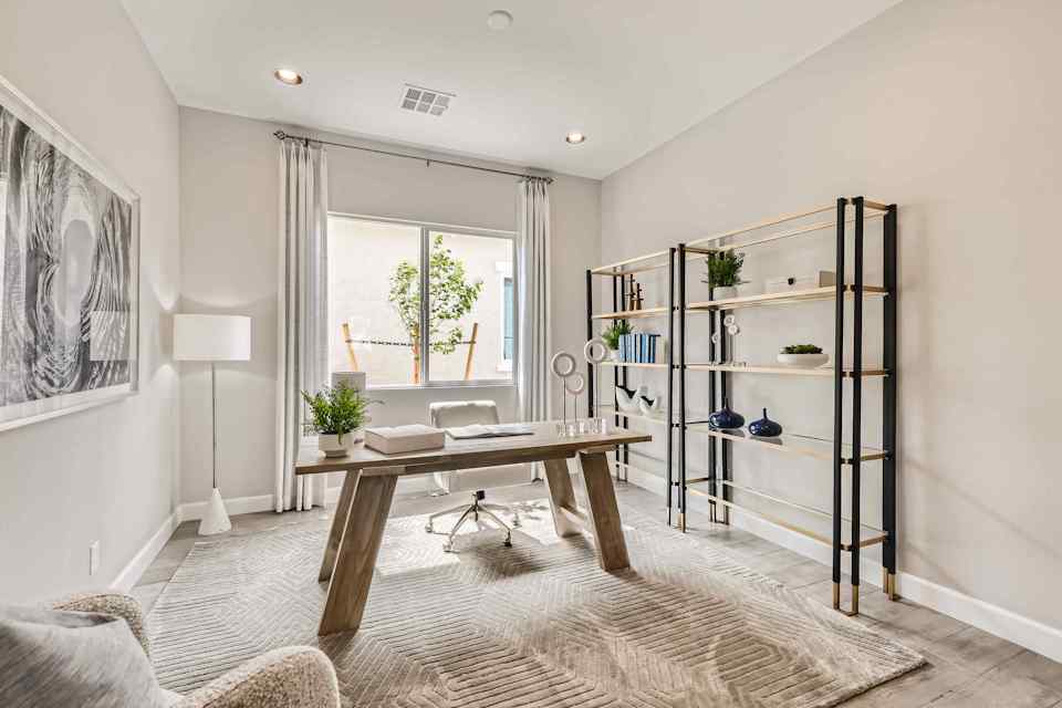 A room with a table and a shelf with objects on it.