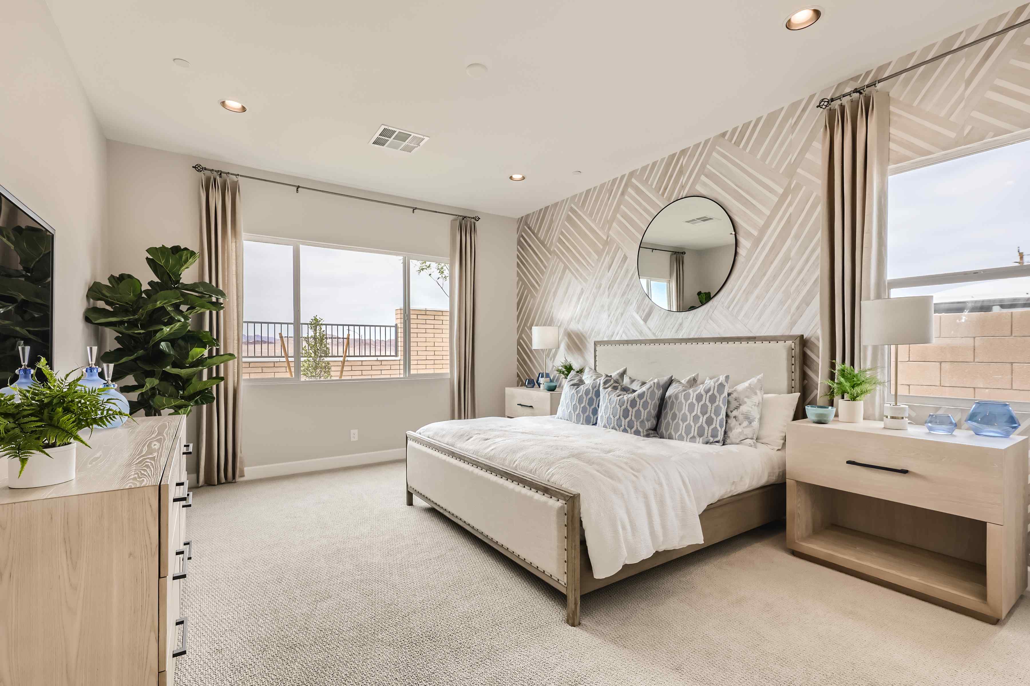 A bedroom with a large window.