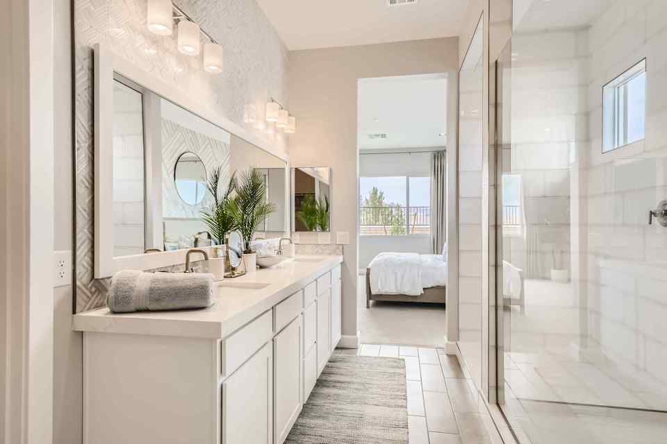 A bathroom with a large mirror.