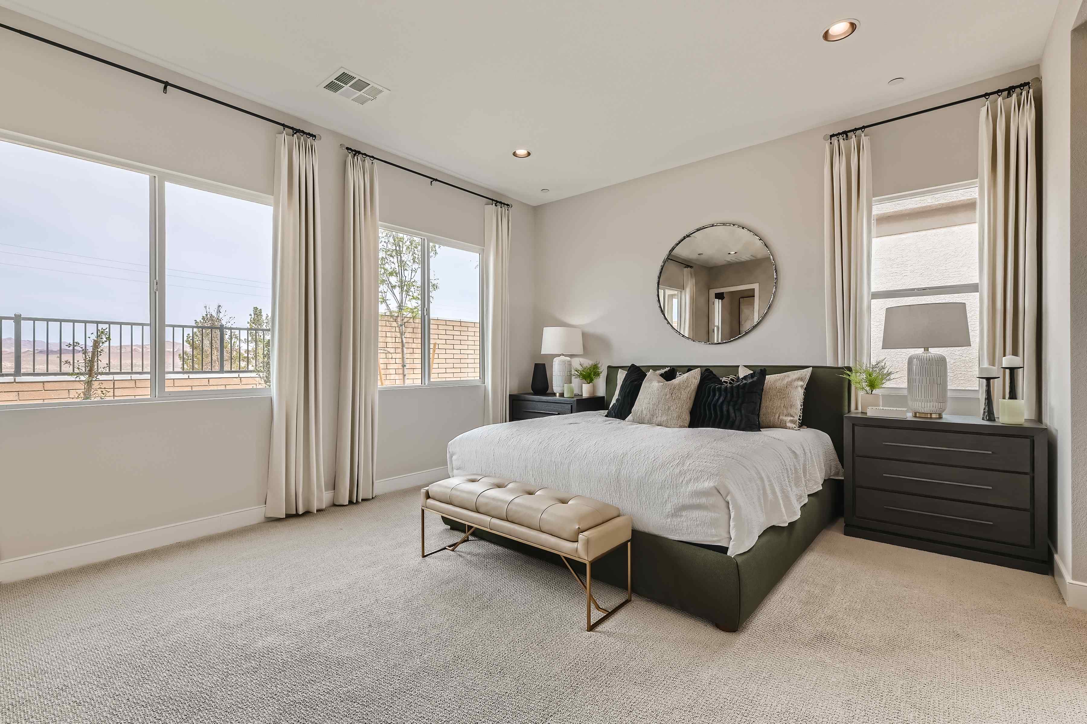 A bedroom with a large window.