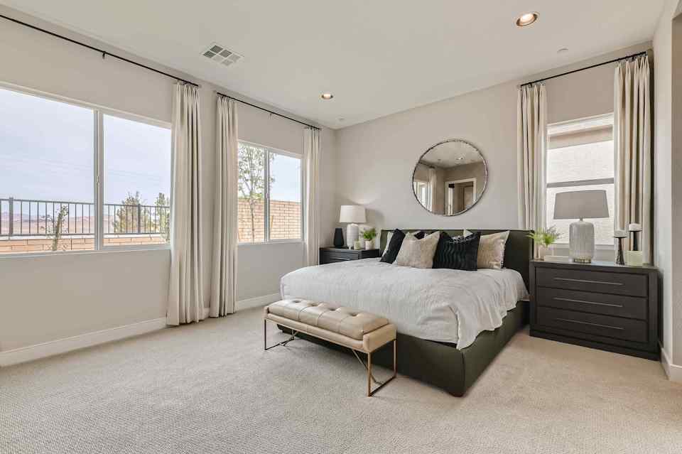 A bedroom with a large window.