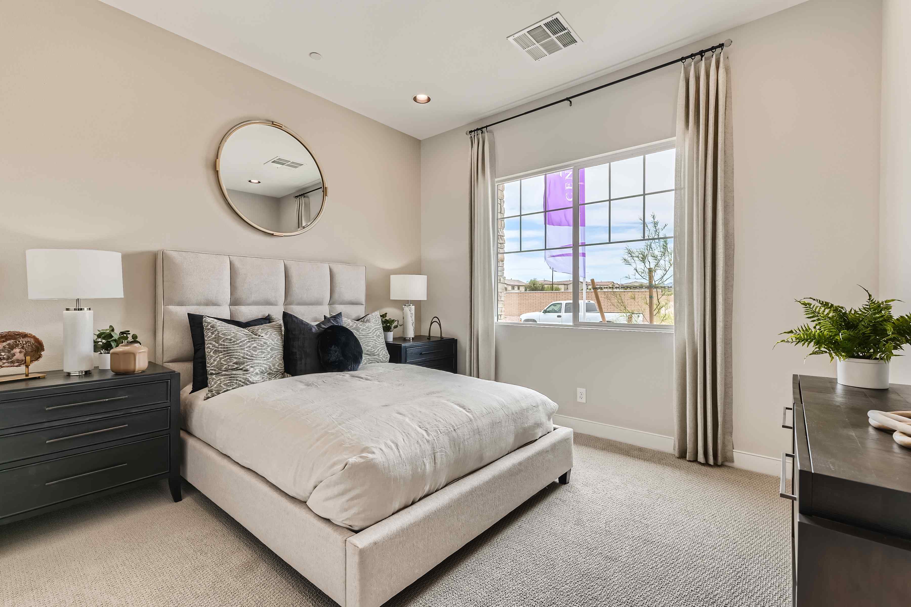 A bedroom with a large window.