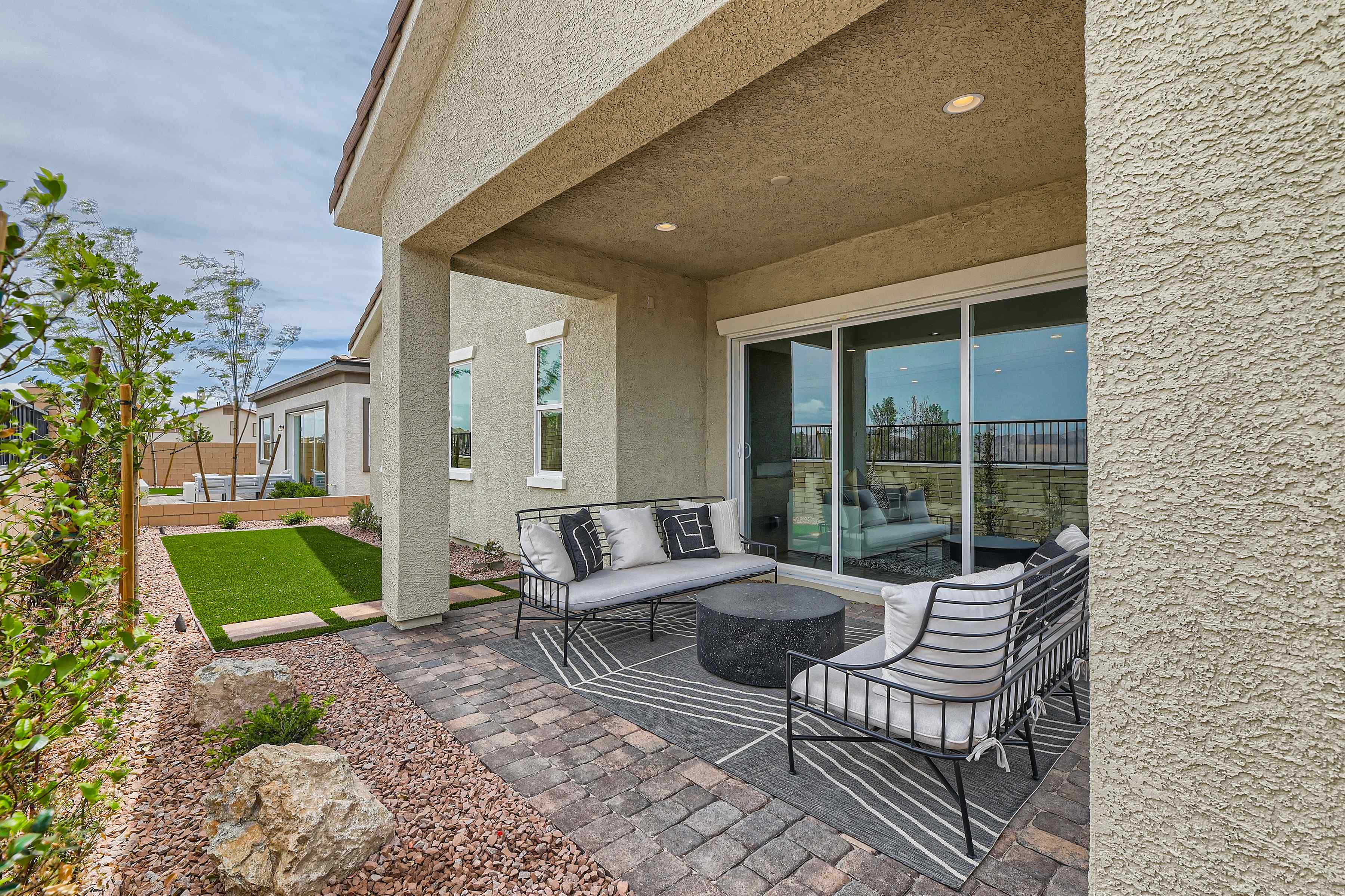 A patio with a couch and chairs.