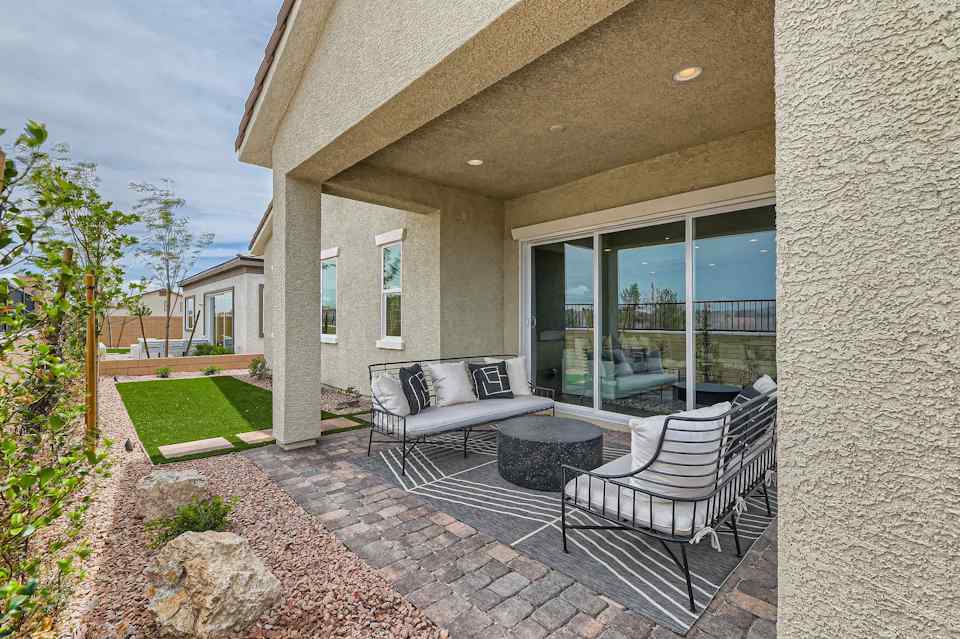 A patio with a couch and chairs.