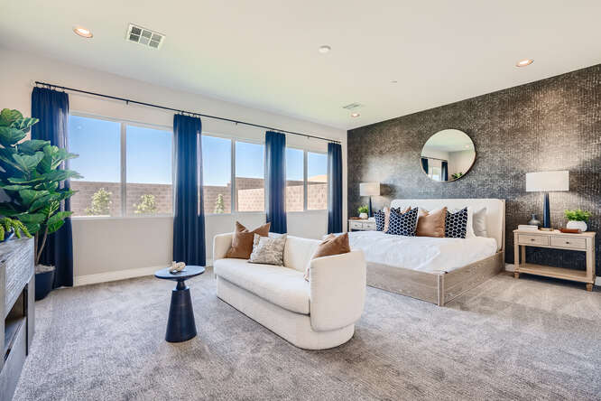 A room with a couch and a table with a mirror.