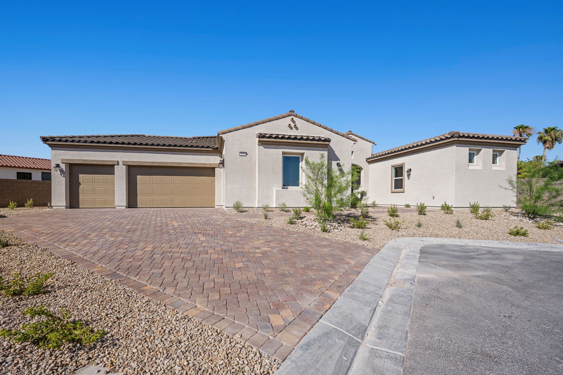 A house with a brick driveway.