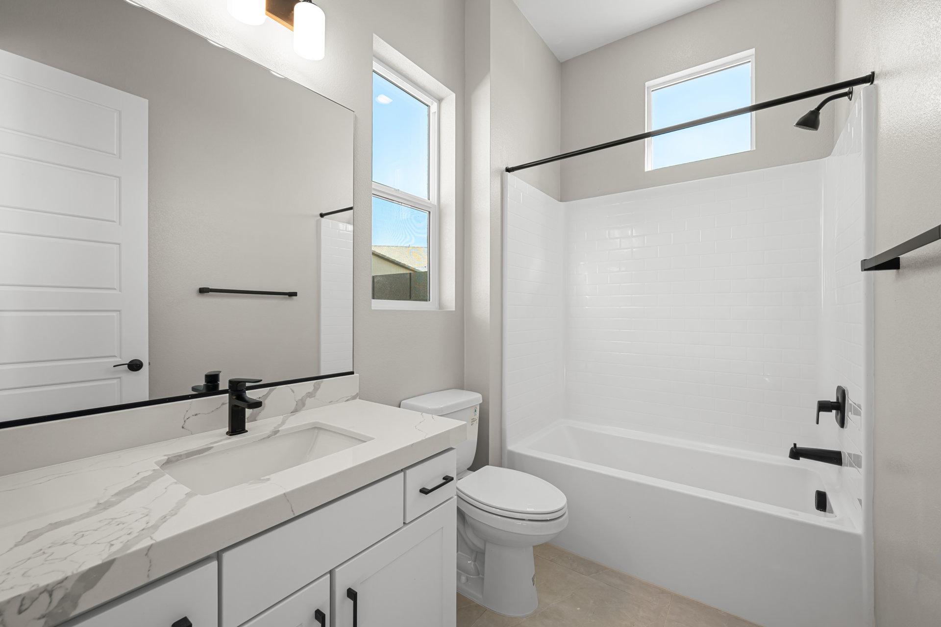 A bathroom with a tub sink and toilet.