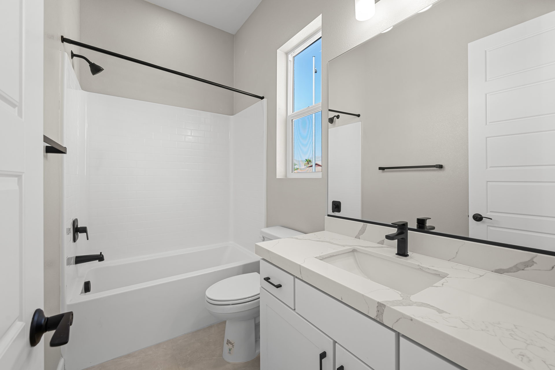 A bathroom with a tub sink and toilet.
