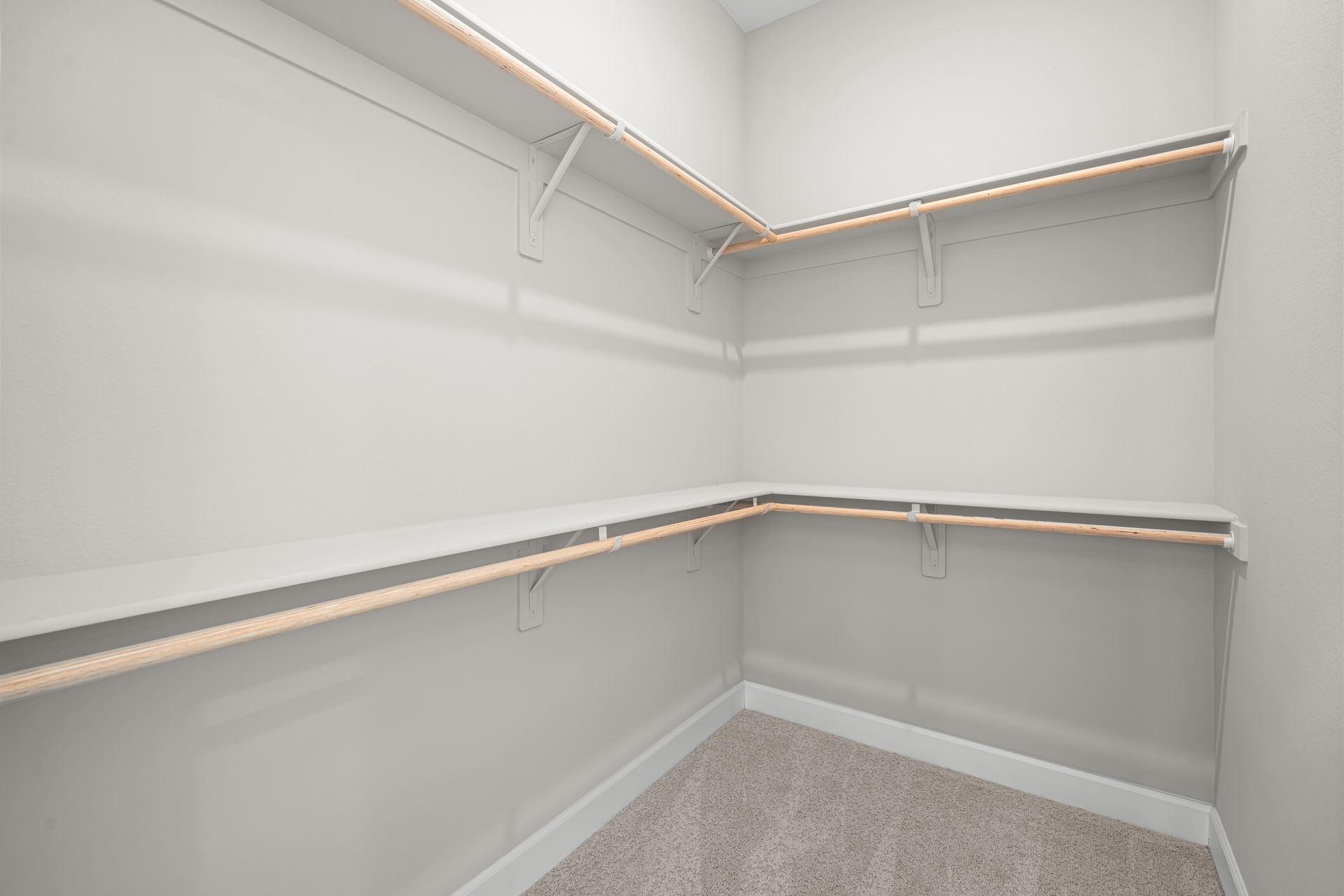A white wall with a metal bar.