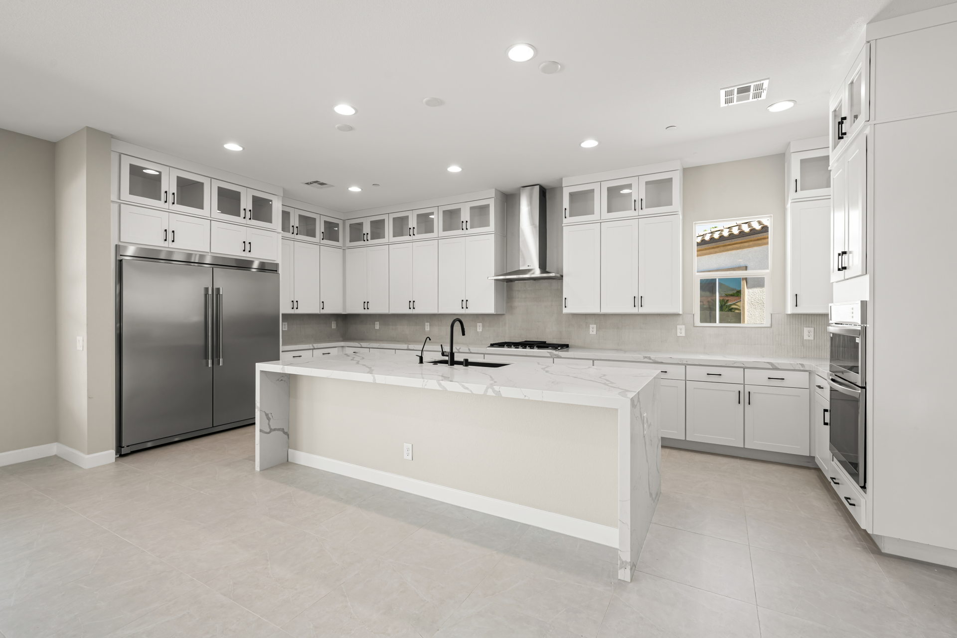 A kitchen with white cabinets.