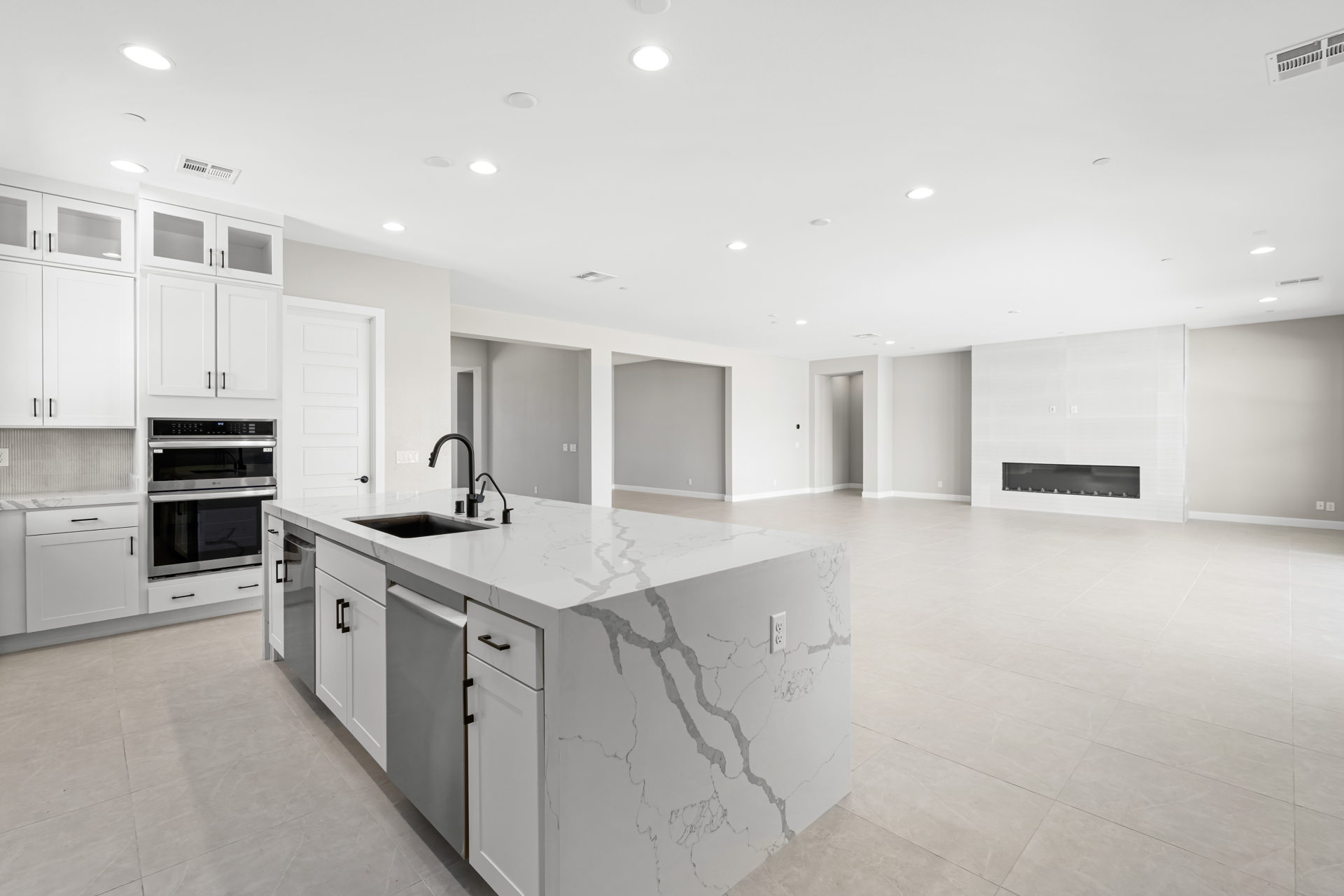 A kitchen with white cabinets.