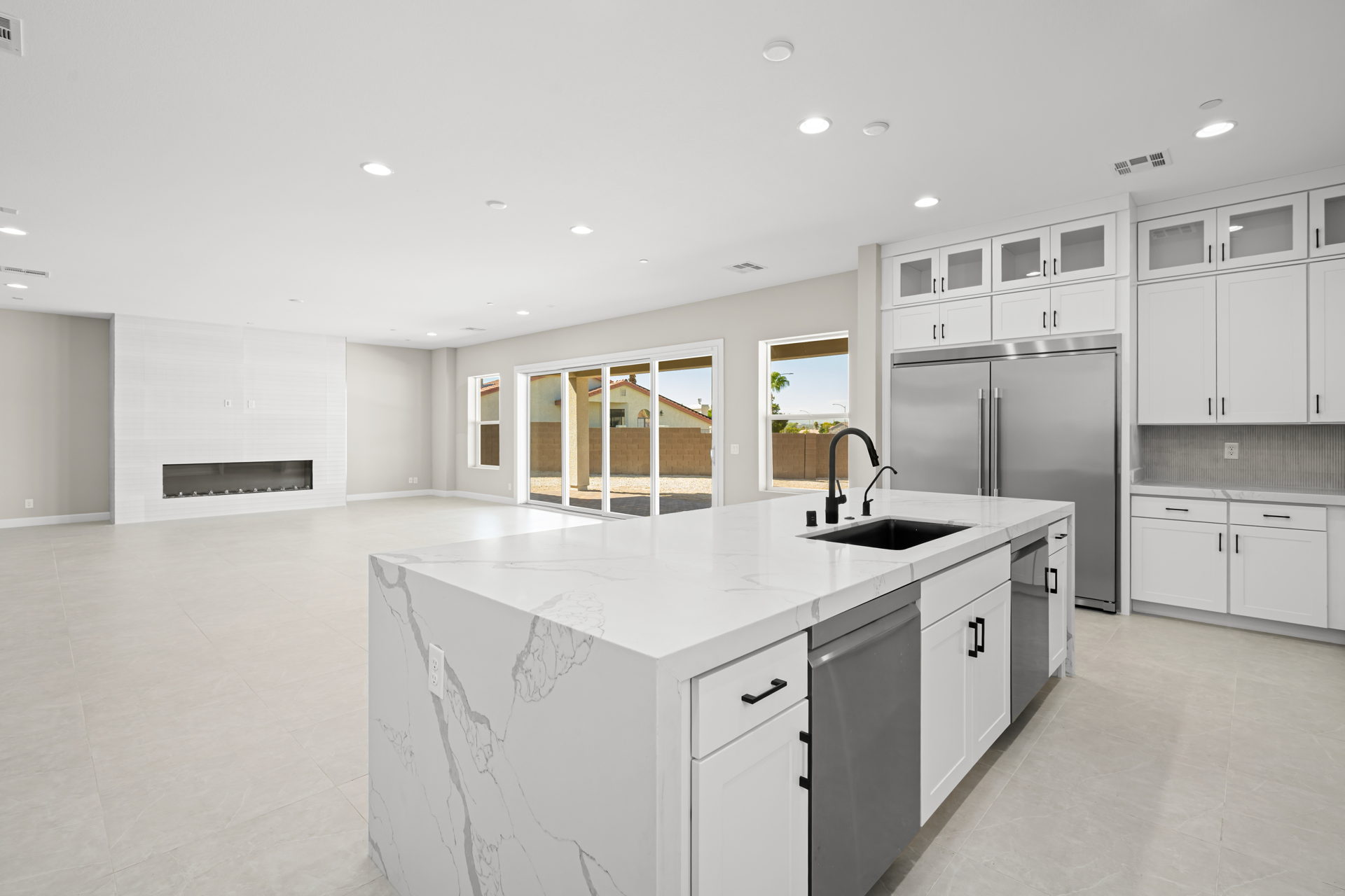 A kitchen with white cabinets.