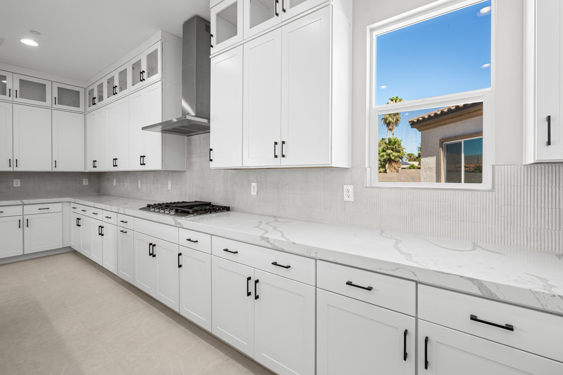 A kitchen with white cabinets.