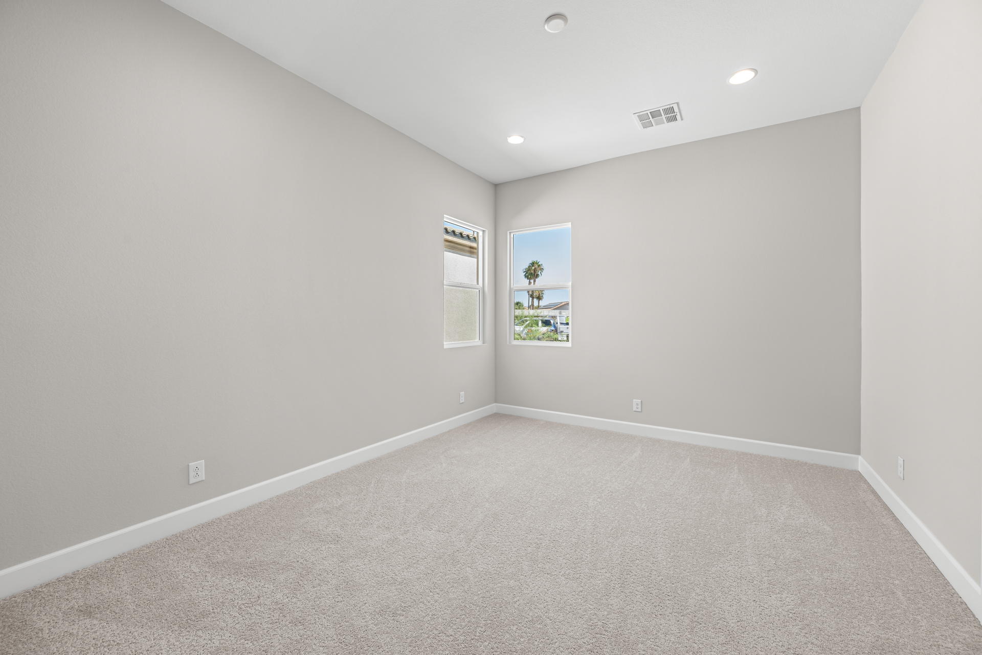 A white room with a white carpet.