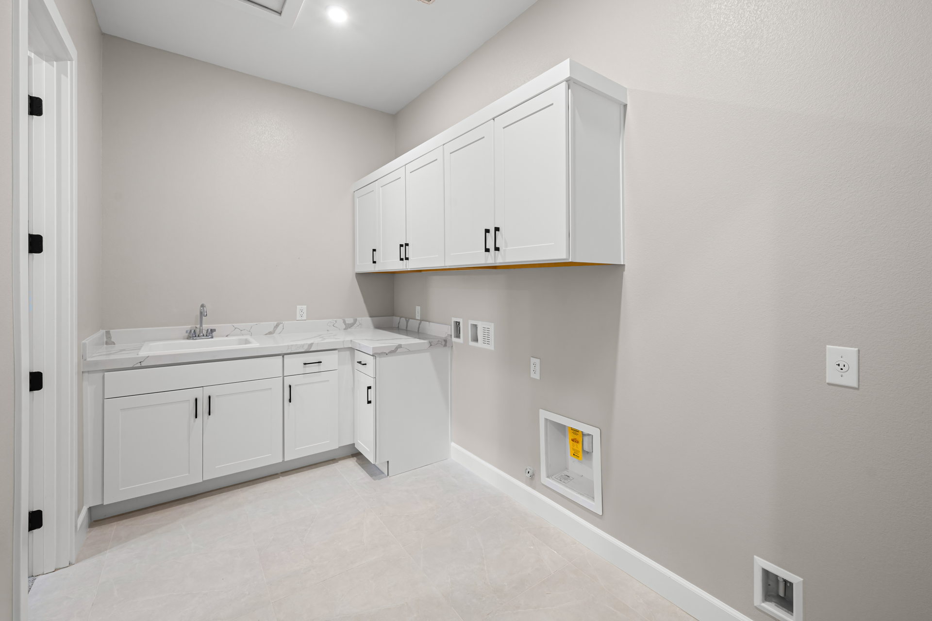 A white kitchen with white cabinets.
