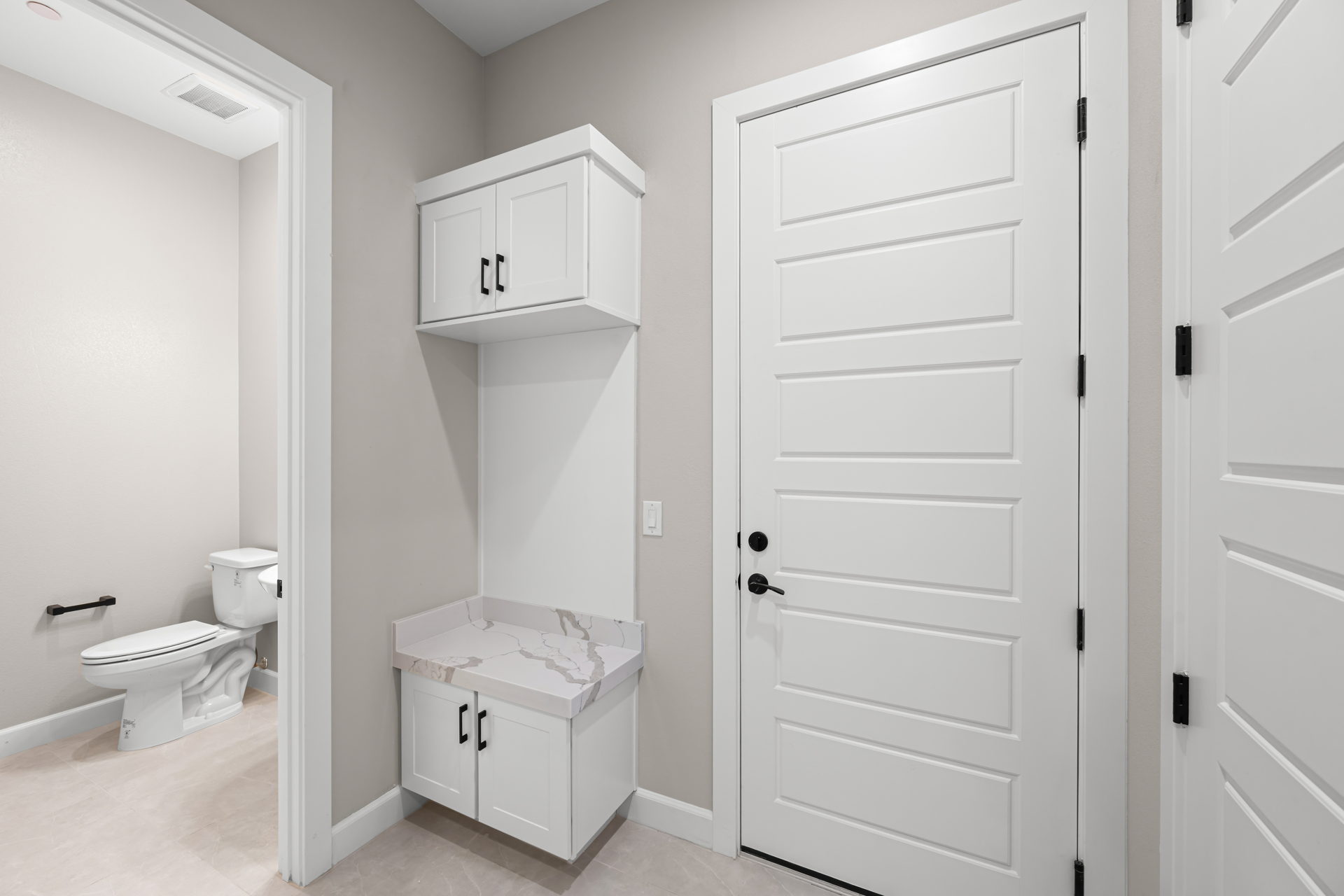 A white bathroom with a toilet and a sink.