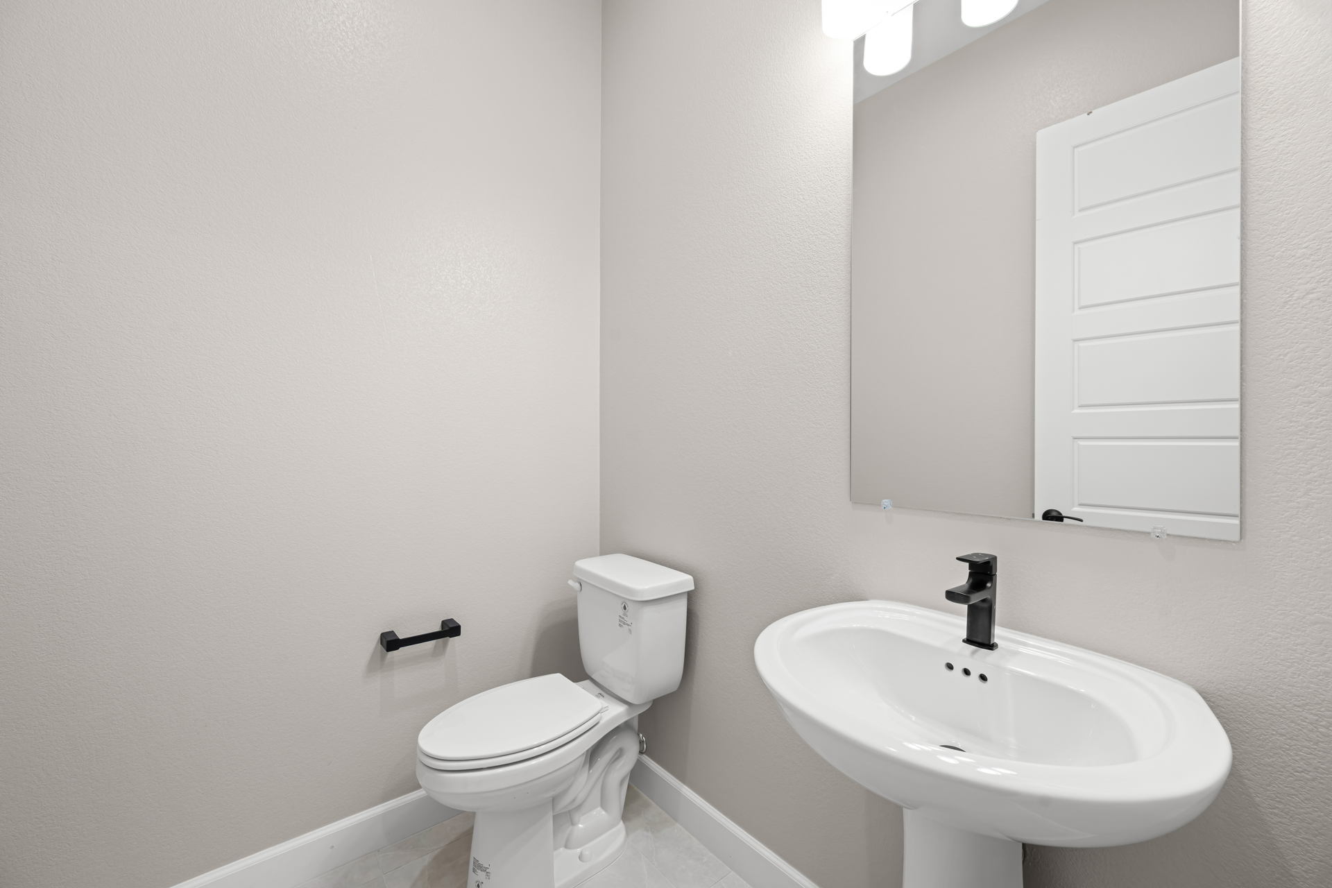 A bathroom with a toilet and sink.