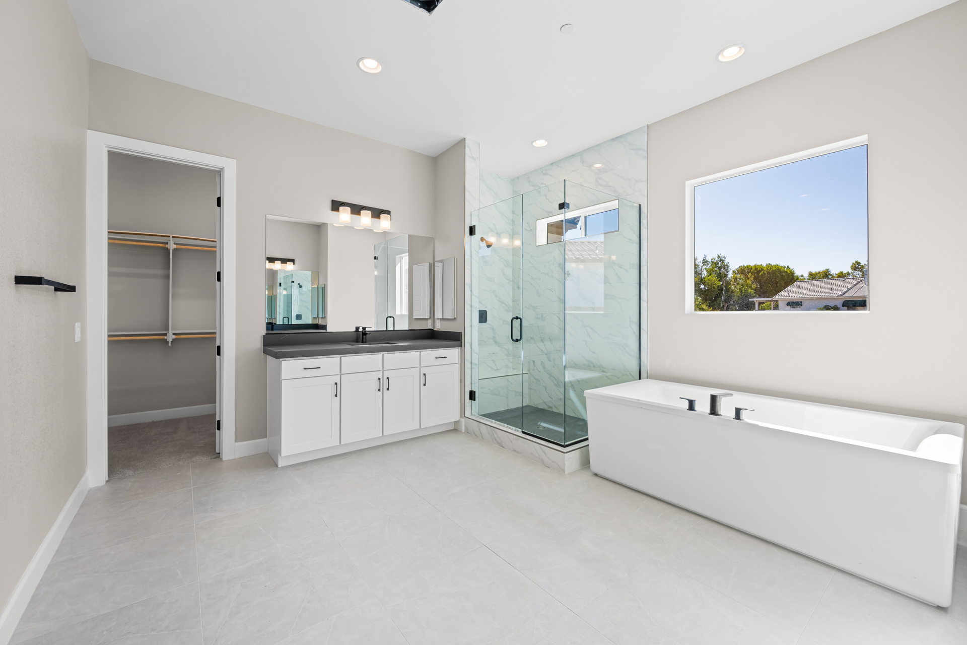 A bathroom with a bathtub and a shower unit.