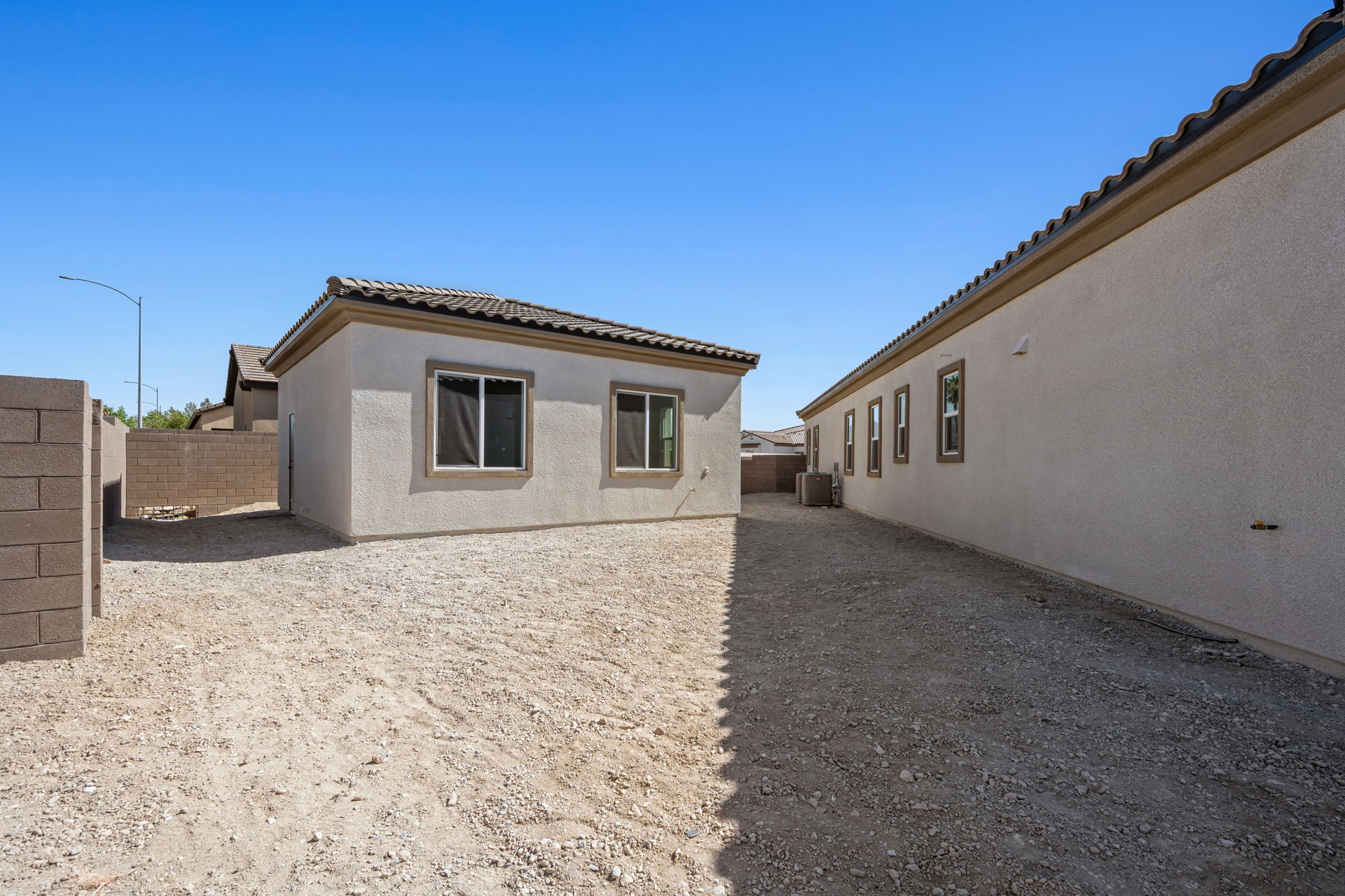 A building with a dirt road.