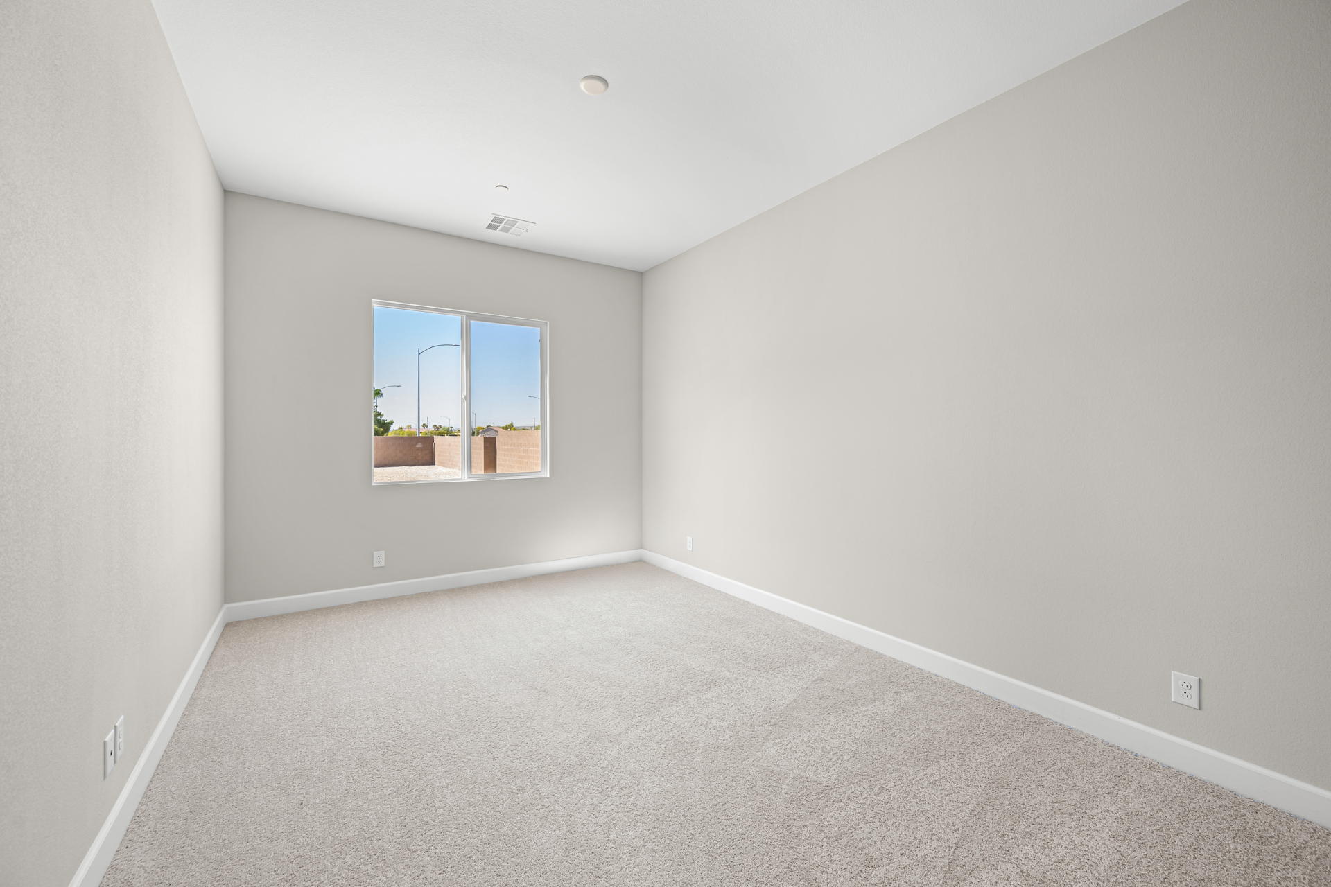 A room with a window and a carpet.