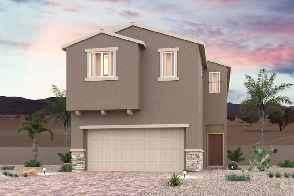 A house with a garage and palm trees.