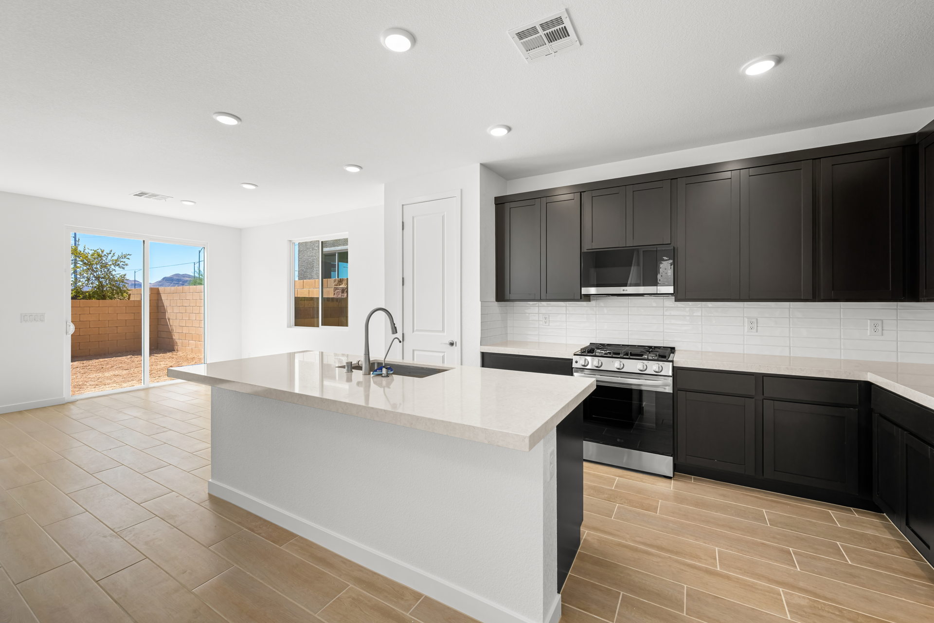 A kitchen with black cabinets.