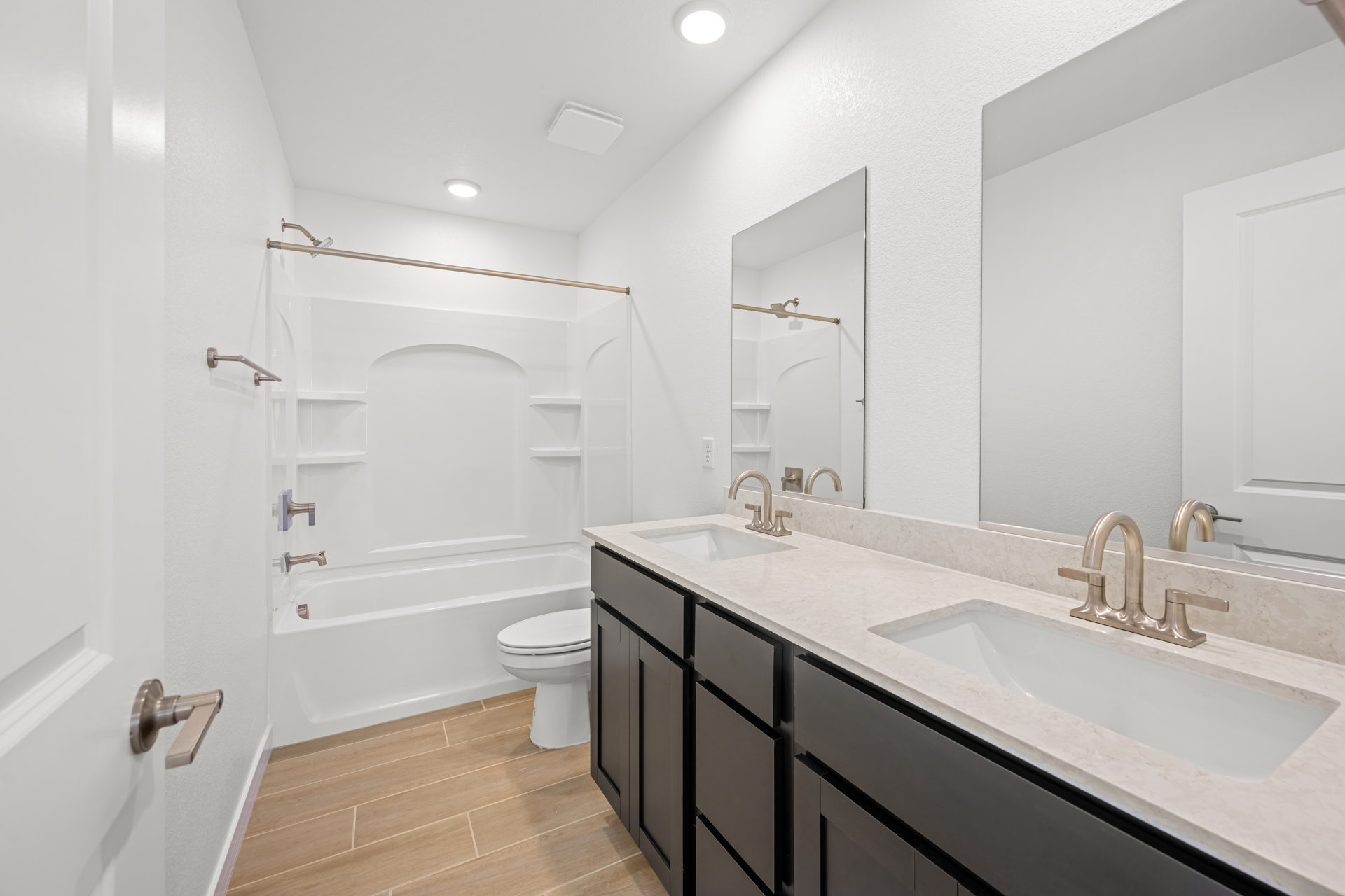 A bathroom with a tub sink and toilet.