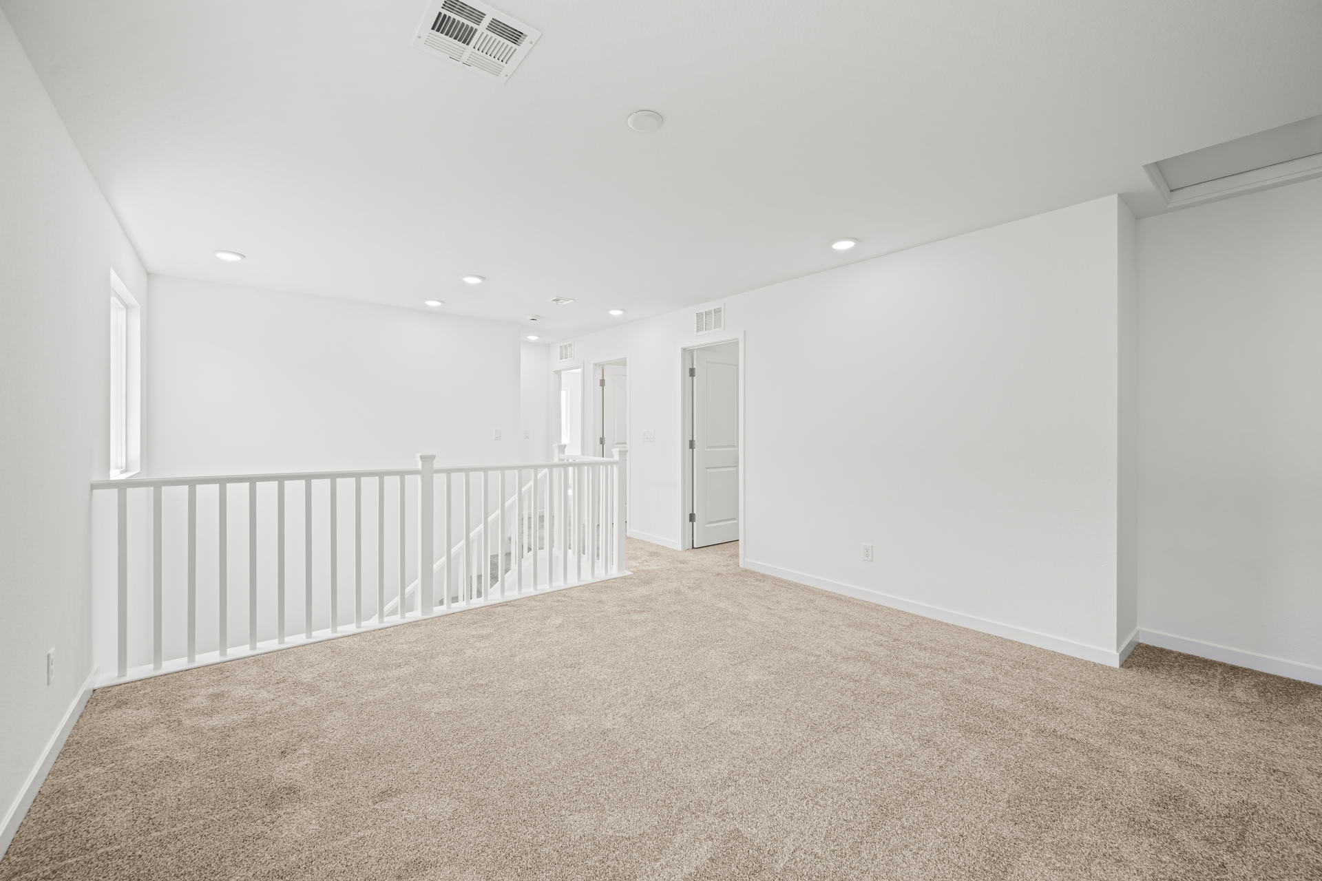A long hallway with white walls.
