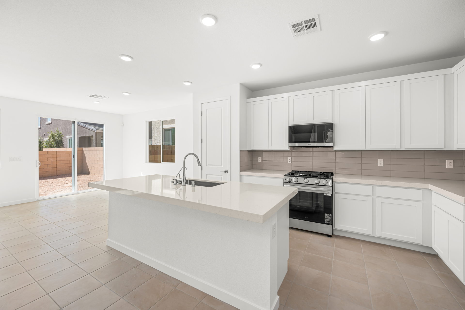 A kitchen with white cabinets.