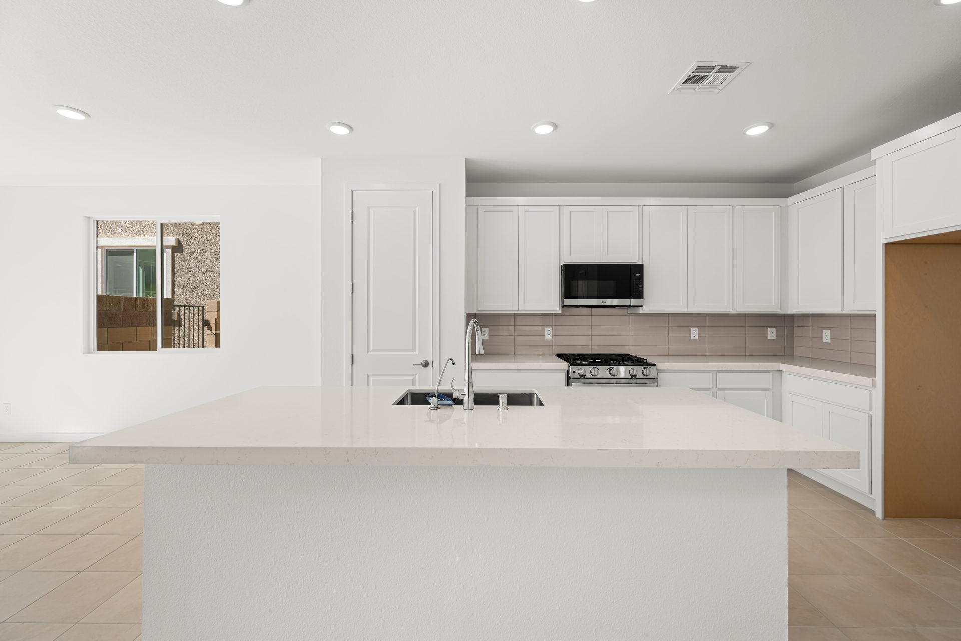 A kitchen with white cabinets.