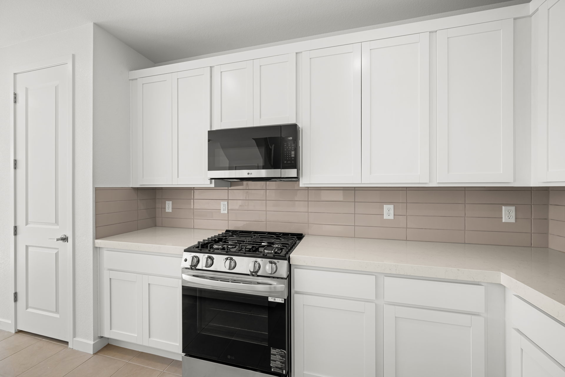 A kitchen with white cabinets.