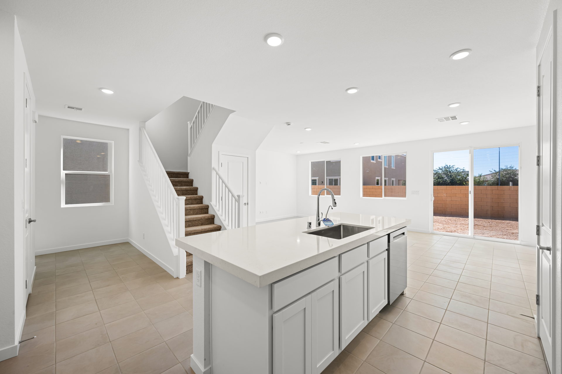 A kitchen with white cabinets.