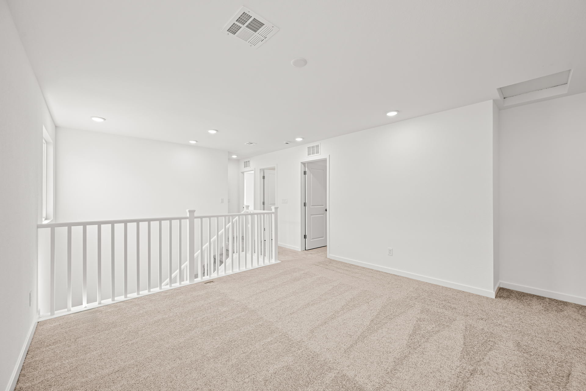 A long hallway with white walls.