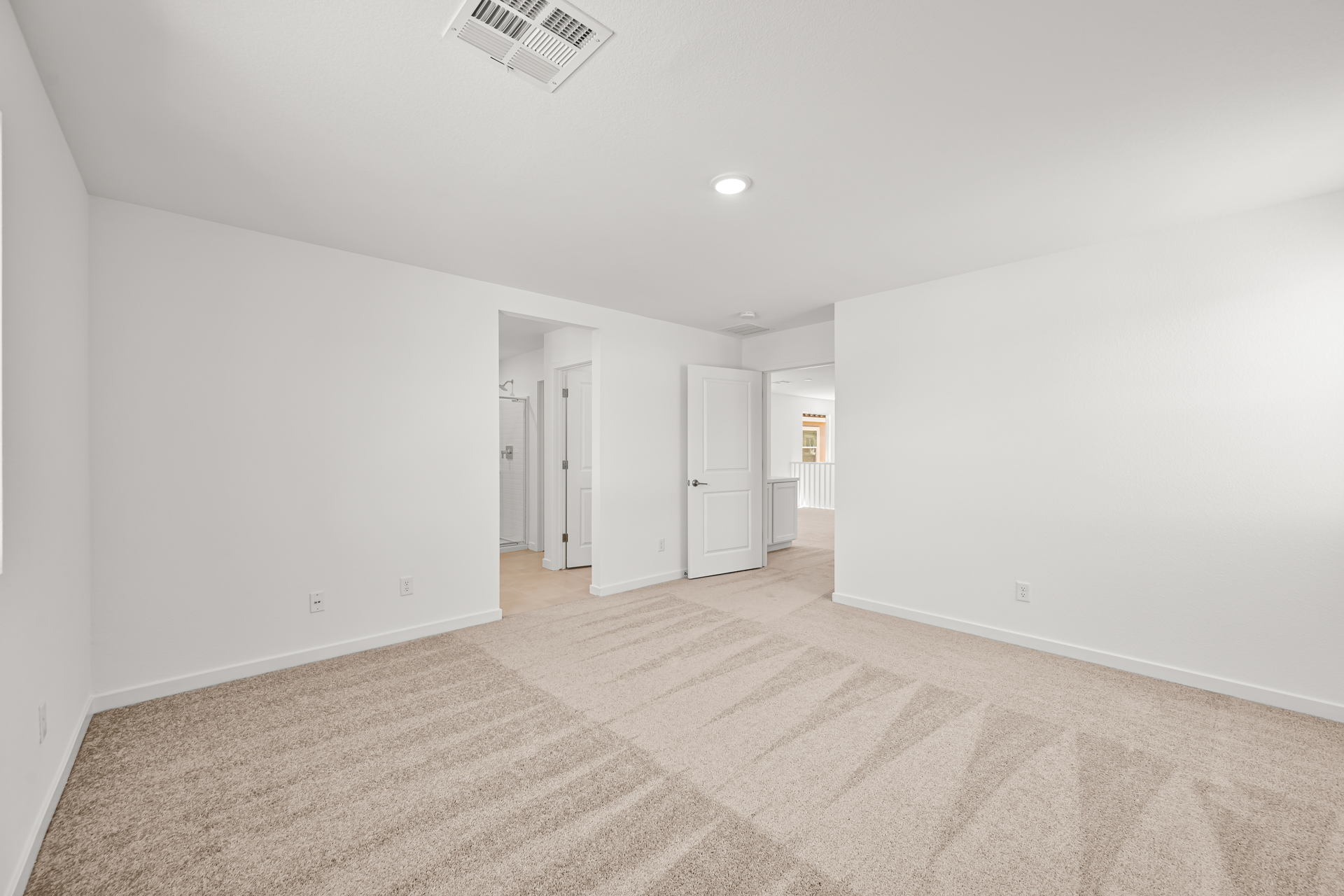 A long hallway with white walls.