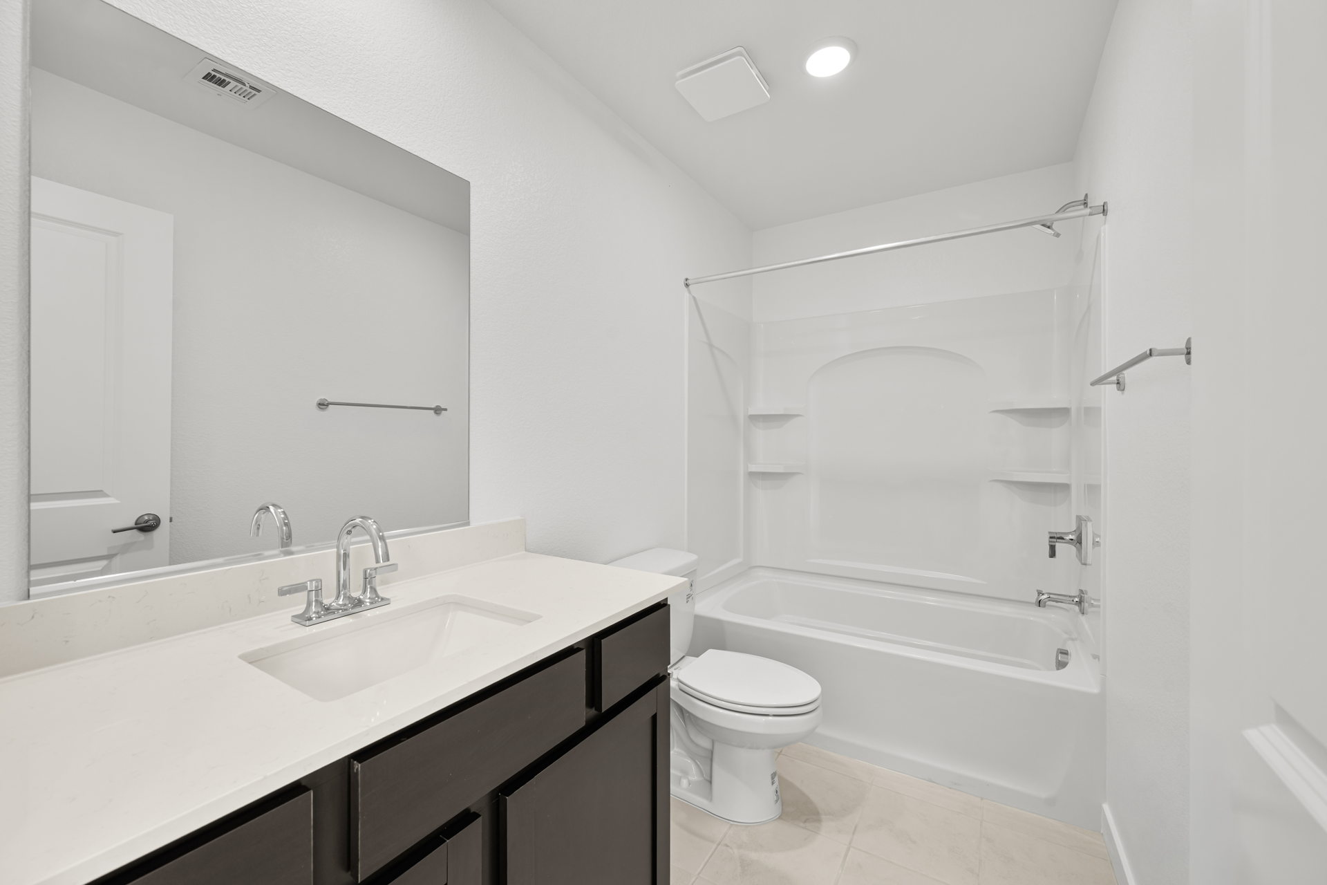 A bathroom with a sink toilet and shower.