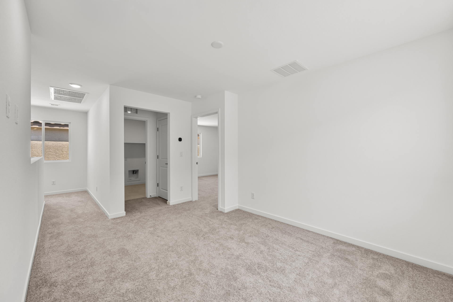 A hallway with white walls.