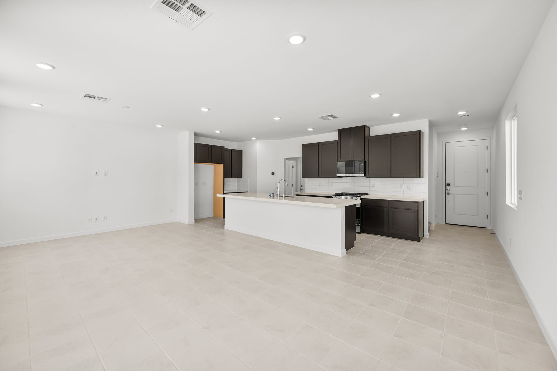 A large kitchen with white tile.