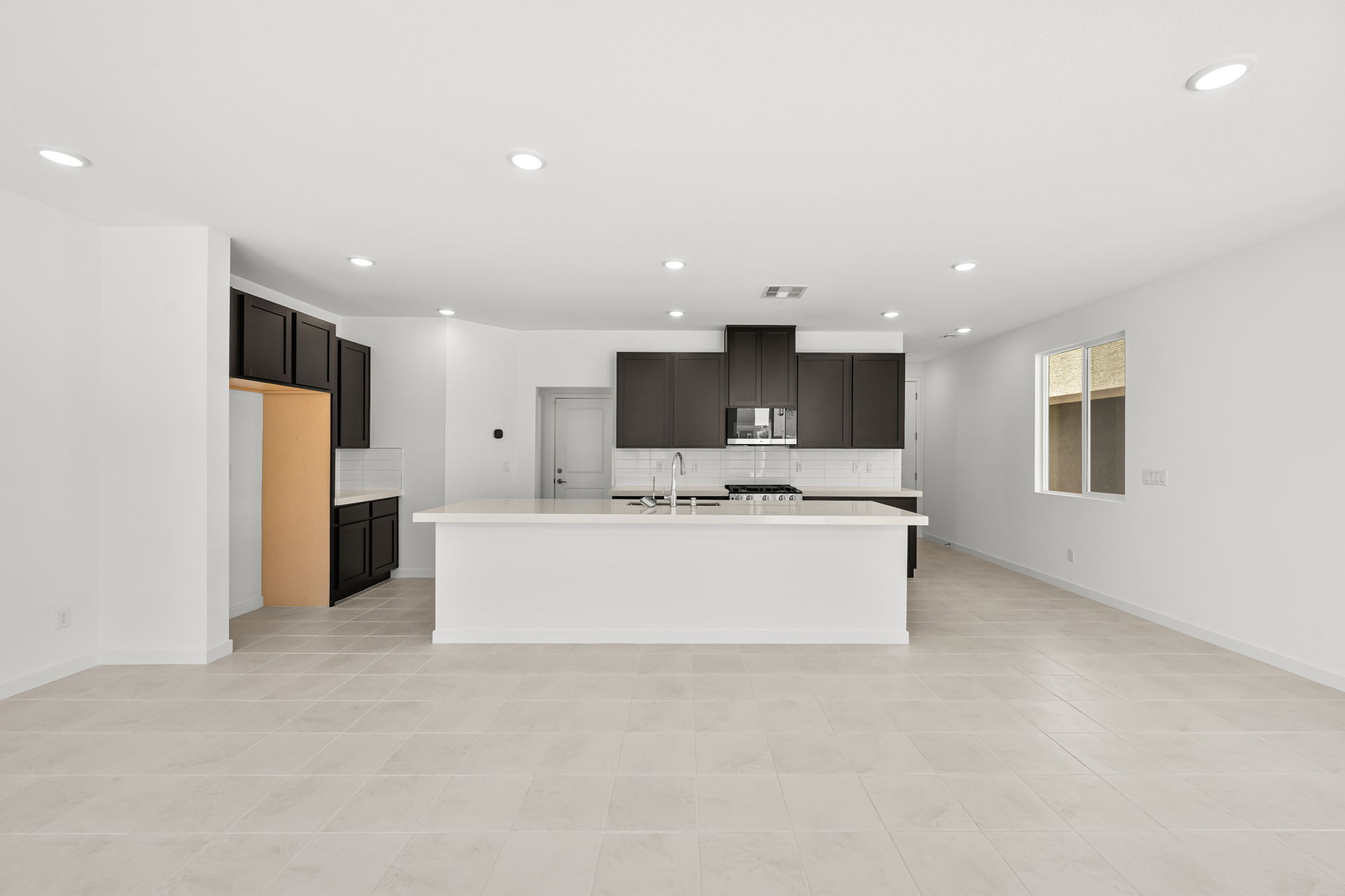 A large kitchen with white walls.